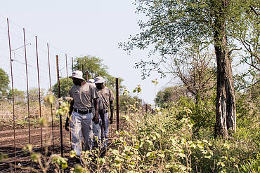 Village police near the fence on patrol