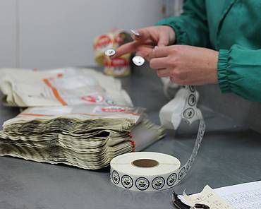 Getting stickers ready for packaging vegetables